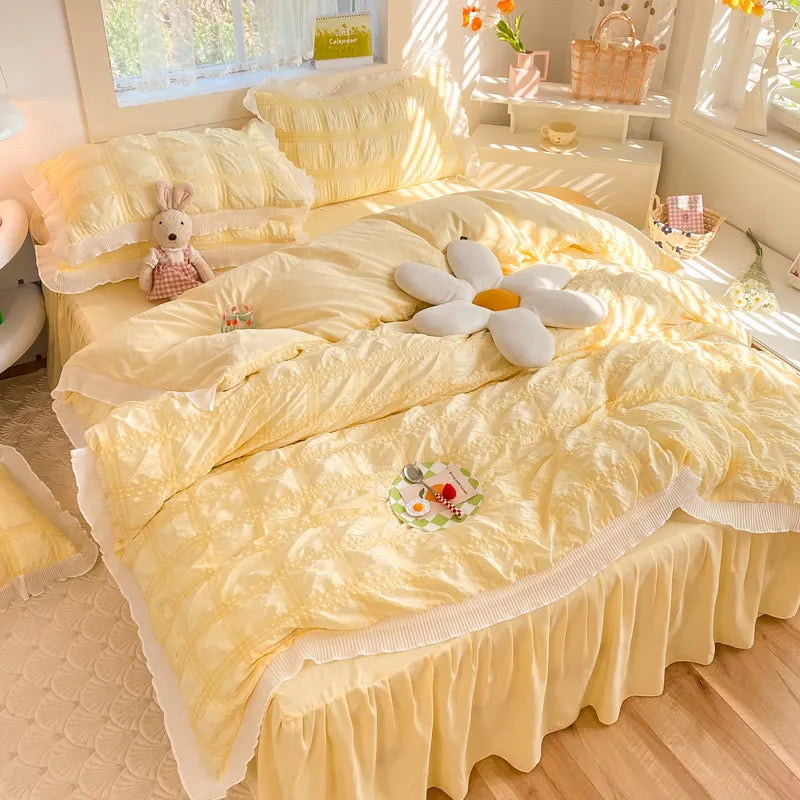 Close-up of soft ruffled duvet cover with delicate lace trim and pillow shams